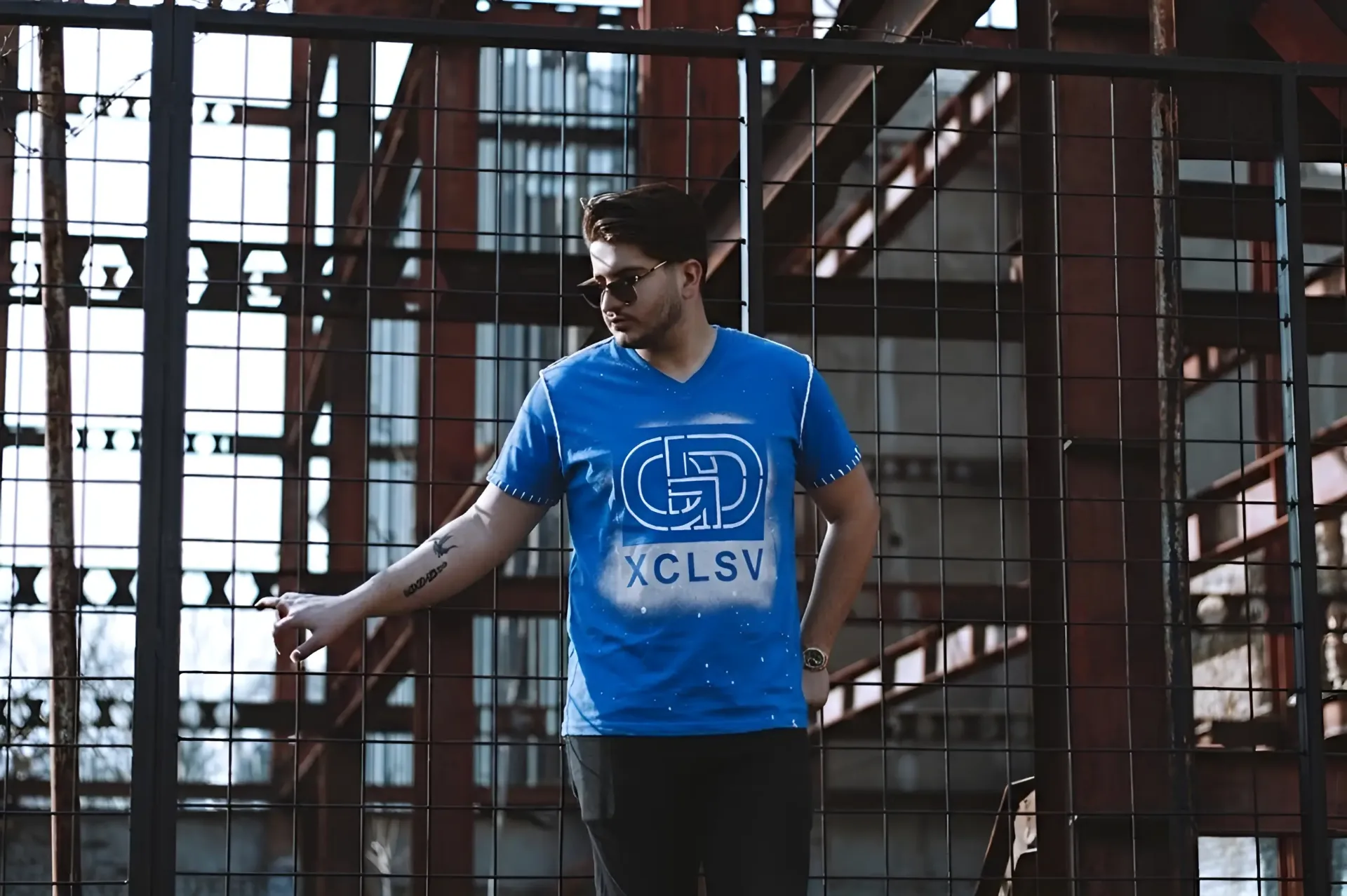 Generational Drip XCLSV tee, motivational streetwear industrial backdrop